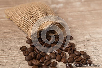 straw cover with coffee beans on an old wooden table Stock Photo