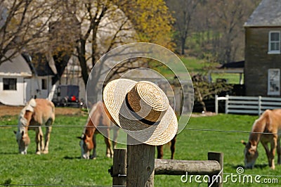 Straw hat with Amish farm in the background Stock Photo