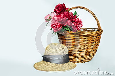 Straw hat with a bouquet of luxurious pink peonies Stock Photo