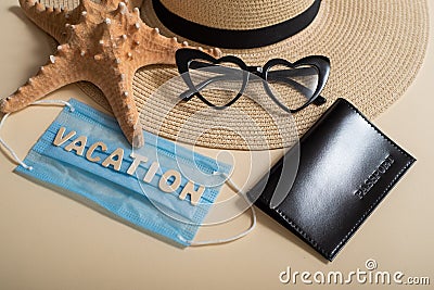 Straw hat sunglasses in the shape of a heart, passport, starfish and mask with the inscription vacation. Vacation Stock Photo