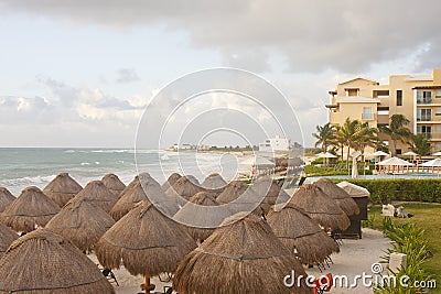 Straw Thatched Beach Huts at Tropical Resort Stock Photo