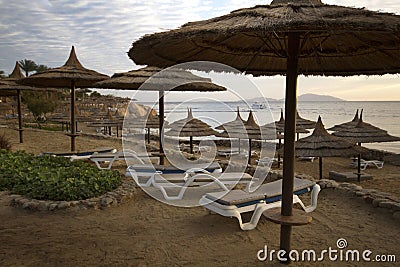Straw umbrella on the beach in Red Sea coastline in Sharm El She Stock Photo