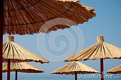 Straw umbrellas on a beach Stock Photo