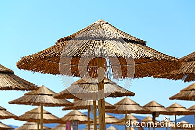 Straw umbrellas on the beach Stock Photo