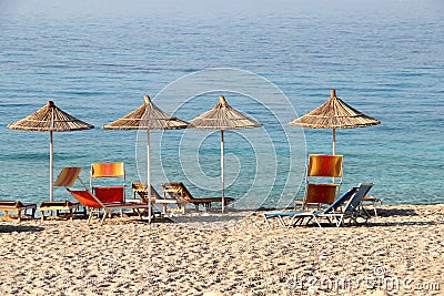 Straw umbrellas on the beach Stock Photo