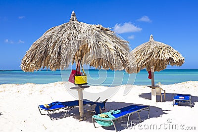 Straw umbrellas on a tropical beach Stock Photo