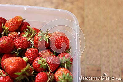 Red strawberries in a container. Summer berry Stock Photo