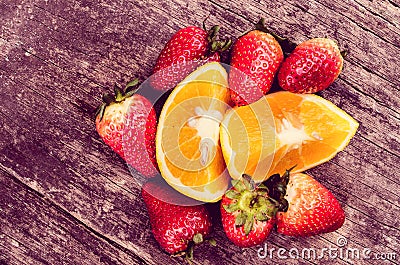 Strawberries and oranges on wood Stock Photo