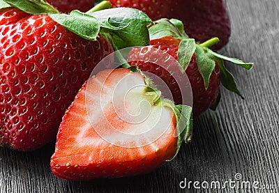 Strawberries ripe, red, whole, half, close-up on a dark background Stock Photo