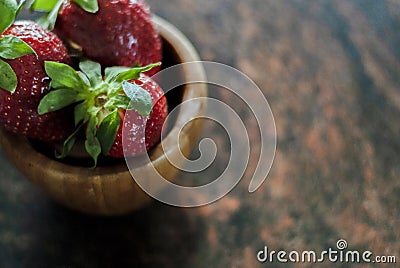 Strawberries in a wood bowl with natural light Stock Photo