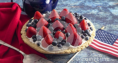 A Strawberry and Blueberry Fresh Summer Pie on a Distressed Blue Wooden Table Stock Photo