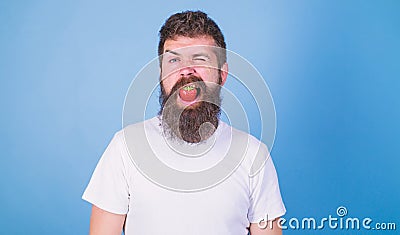 Strawberry breath freshener concept. Man handsome hipster with long beard eating strawberry. Freshness comes in red Stock Photo