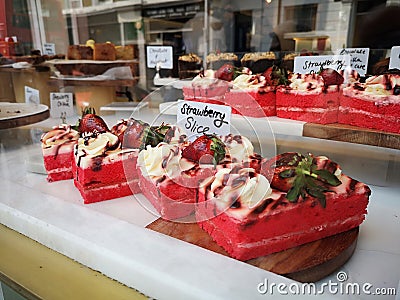 Strawberry cake on a counter show window in Portobello Market, Notting Hill Editorial Stock Photo