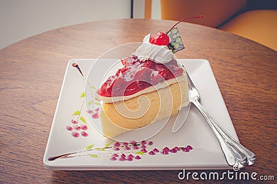 Strawberry cheese cake dessert put on white plate that decorate with jam. Stock Photo