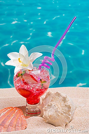 Strawberry cocktail on beach sand with seashells Stock Photo