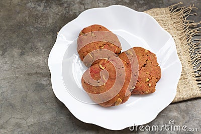 Strawberry cookies cashew nuts raisin in plate on stone table Stock Photo