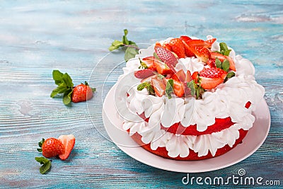 Strawberry and cream sponge cake. Homemade summer dessert on blue wooden table Stock Photo