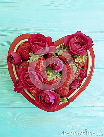 Strawberry dish heart, flower rose dessert on colored wooden background Stock Photo