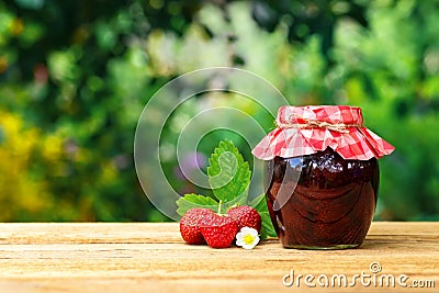 Strawberry jam in jar on table Stock Photo