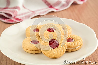 Strawberry jam sandwich biscuits on plate Stock Photo