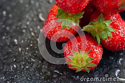 Strawberry. Juicy ripe strawberries with water drops on a wet dark background. Red berries. Copy space. Close-up. Selective focus Stock Photo