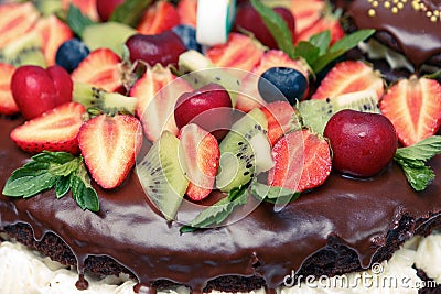 Strawberry, kiwi, cherry, mint, leaves, cream on sweet brown Stock Photo