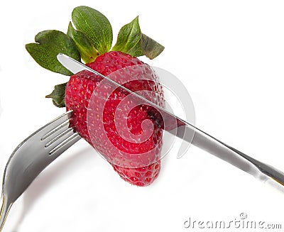 Strawberry with a knife and fork Stock Photo