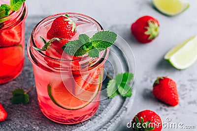 Strawberry lime lemonade with fresh mint and ice in glass jar Stock Photo