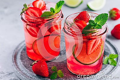 Strawberry lime lemonade with fresh mint and ice in glass jar Stock Photo