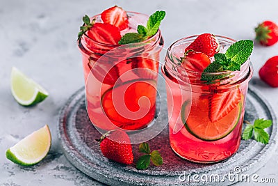 Strawberry lime mojito with fresh mint and ice in glass jar Stock Photo