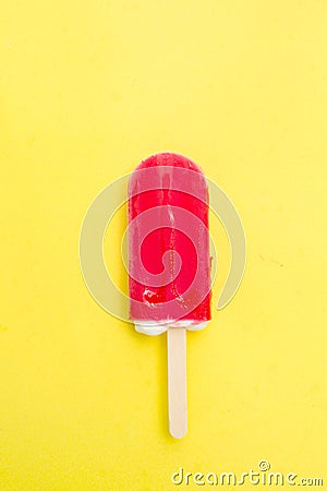 Strawberry popsicle on yellow Stock Photo