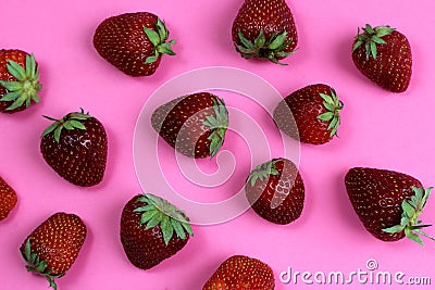 Texture strawberry on a pink background. Ripe fresh strawberry berries close-up. View from above Stock Photo