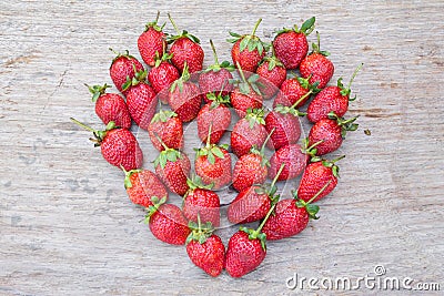 Strawberry shape heart on dry wood Stock Photo