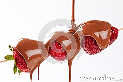 Strawberry skewer with melted milk chocolate Stock Photo