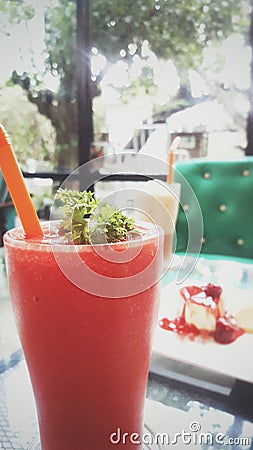 Strawberry smoothie on background is green sofa Stock Photo