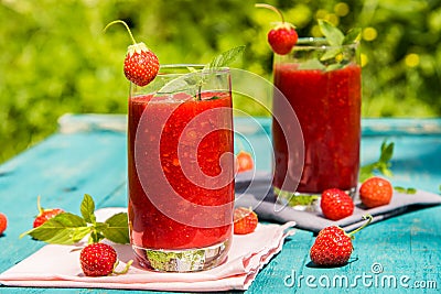 Strawberry smoothies on an old blue wooden surface Stock Photo