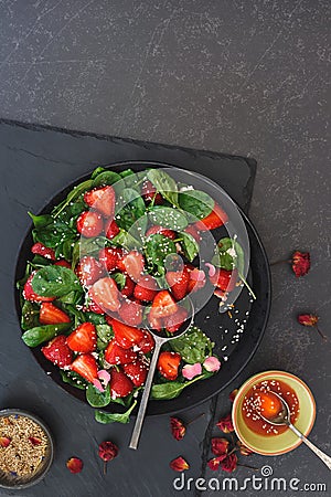 Strawberry Spinach Salad with sesame seeds and rose petals Stock Photo