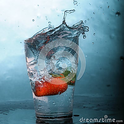 Strawberry in splash glass Stock Photo