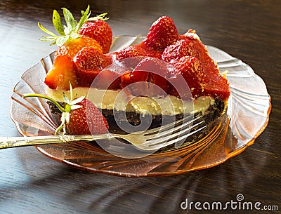 Strawberry tart cake with cream filling on a glass plate with folk Stock Photo