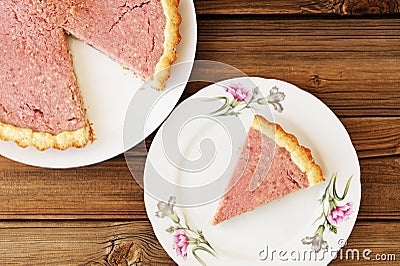 Strawberry tart with cut out piece on separate plate on old wood Stock Photo