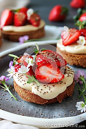 Strawberry tart on dark plate with mint decoration. Macro shot with selective focus Stock Photo