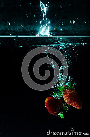 Strawberry water splash on black background Stock Photo