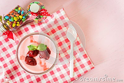 Strawberry yogurt with strawberry on pink background. strawberry yoghurt. pink yogurt. strawberry in strawberry yogurt. heart in Stock Photo