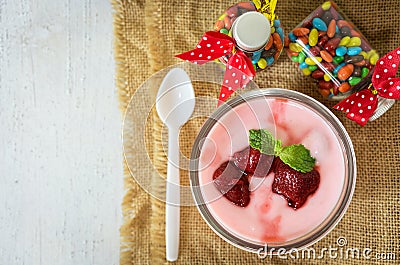 Strawberry yogurt with strawberry on wooden. strawberry yoghurt. pink yogurt. strawberry in strawberry yogurt. heart in yogurt. Stock Photo