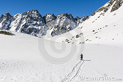 Winter tourism. A road through a snowy valley overlooking beautiful mountain peaks Editorial Stock Photo