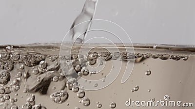 Stream champagne bubbling wineglass closeup. Alcohol wine drink flowing in glass Stock Photo