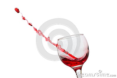 Stream of red wine seemed to fly out piercing a glass Stock Photo