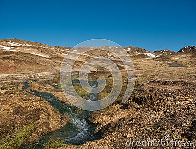 A stream with warm thermal water in the mountains Stock Photo