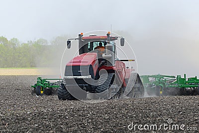Case IH Steiger 580 Quadtrac pulling a Case yield-till system cultivator for spring planting Editorial Stock Photo