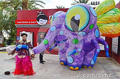 Street actors, giant elephant fly creature Editorial Stock Photo